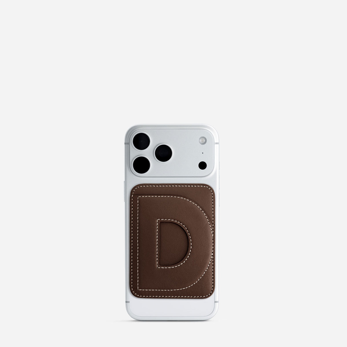 MagSafe cardholder in Espresso, initial D, on phone