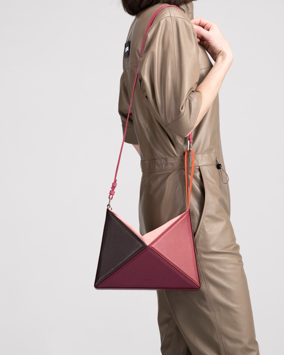 Flex Bag in Cranberry worn on the shoulder with its strap