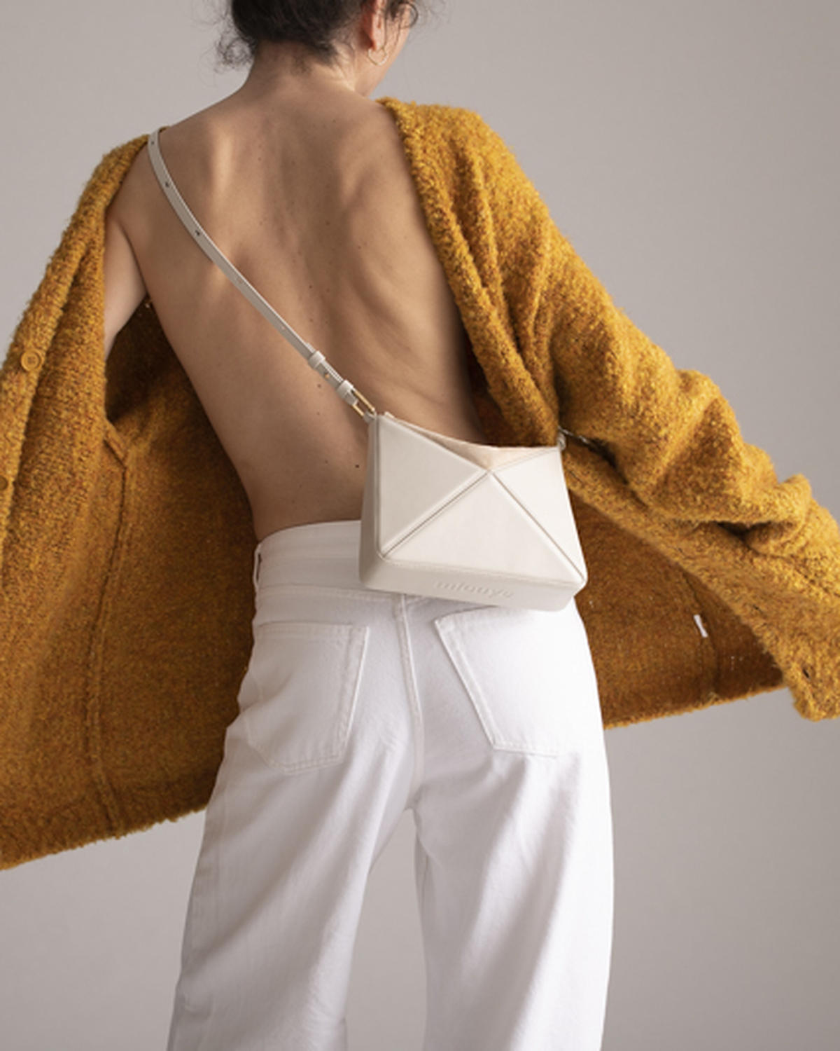 Mini Flex Bag in Dove worn on the shoulder with its strap