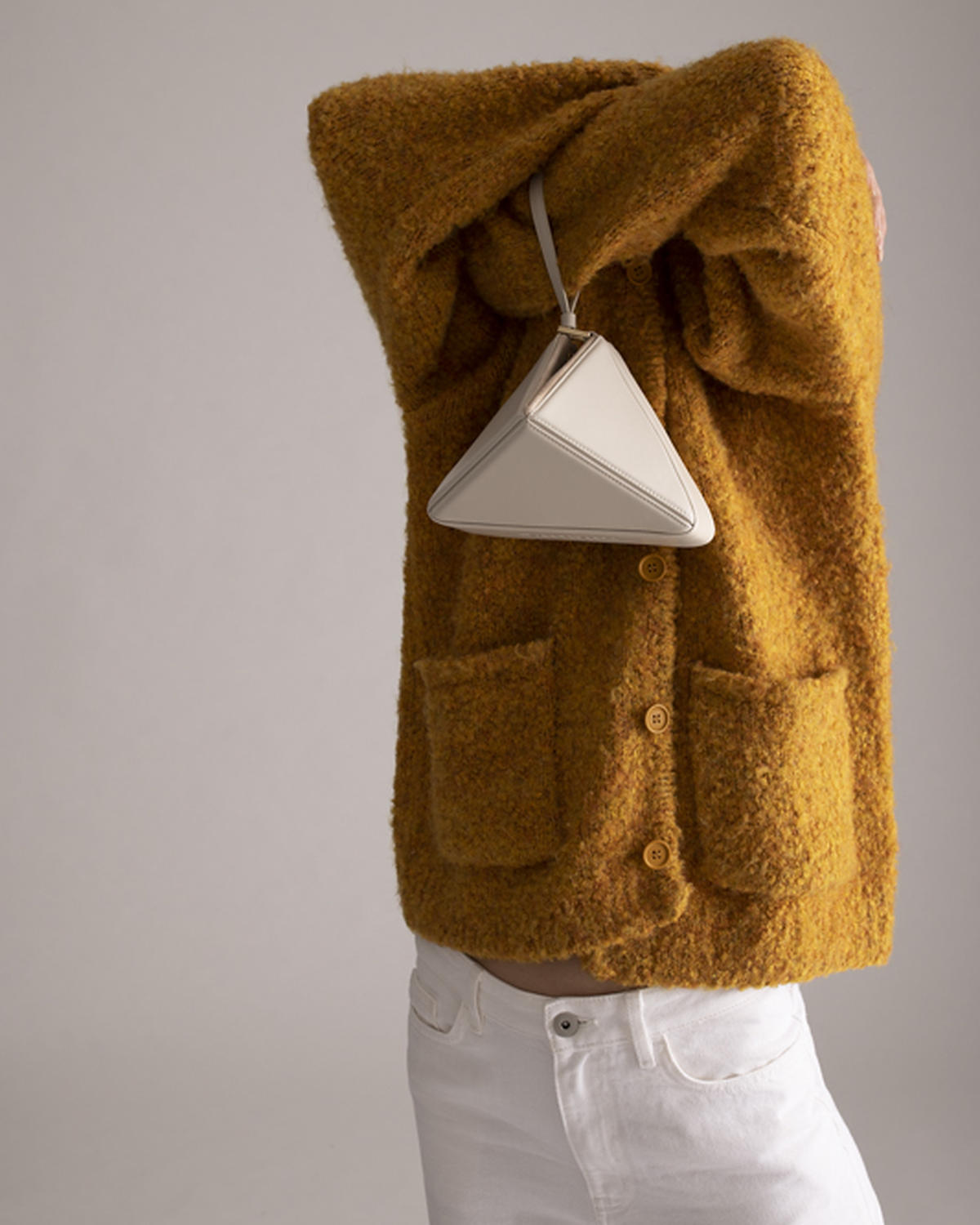 Mini Flex Bag in Dove hanging from the arm by its strap